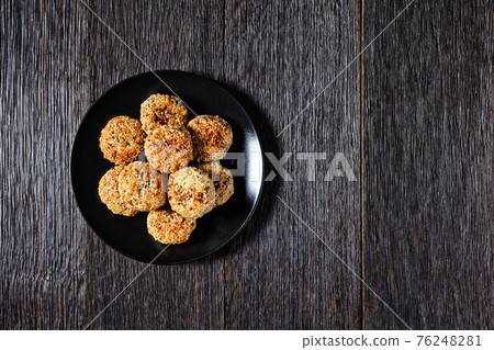 sesame lamb patties on a black plate sesame lamb patties on a black plate 76248281