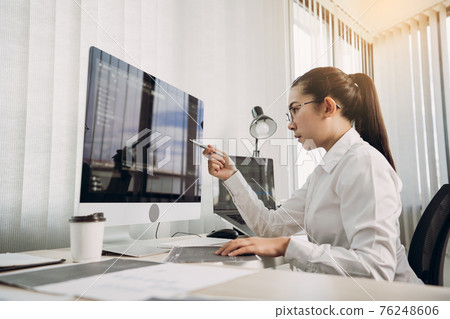 Woman asian software developers are analyzing together about the code written into the program on the computer in office room. Woman asian software developers are analyzing together about the code written into the program on the computer in office room. 76248606