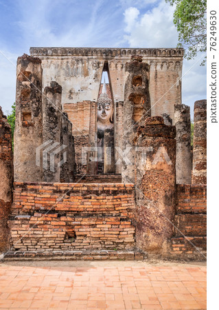Famous big Buddha statue image named Phra Achana situated in ruined chapel at Wat Si Chum temple, Sukhothai Historical Park, Thailand 76249630