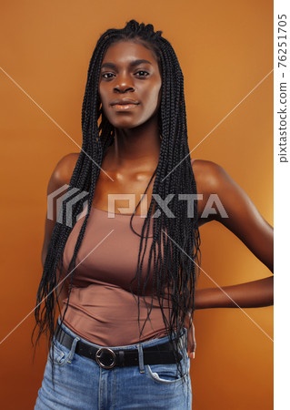 pretty young african american woman with braids posing cheerful gesturing on brown background, lifestyle people concept pretty young african american woman with braids posing cheerful gesturing on brown background, lifestyle people concept 76251705