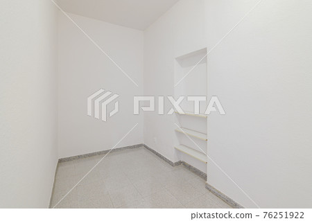 Empty small room with white walls and built-in niche for shelves in an old flat before renovation. Empty small room with white walls and built-in niche for shelves in an old flat before renovation. 76251922