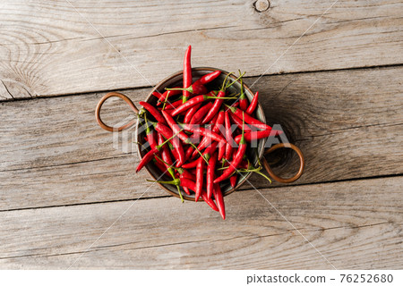 Overhead shot of hot peppers on wooden table 76252680