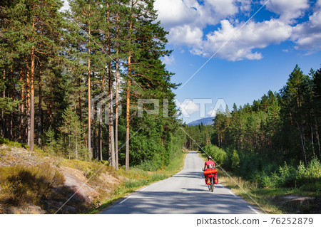 Traveling cyclist on cycle route in Southern Norway Traveling cyclist on cycle route in Southern Norway 76252879