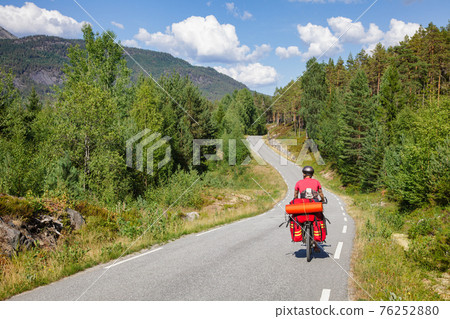 Traveling cyclist on cycle route in Southern Norway Traveling cyclist on cycle route in Southern Norway 76252880