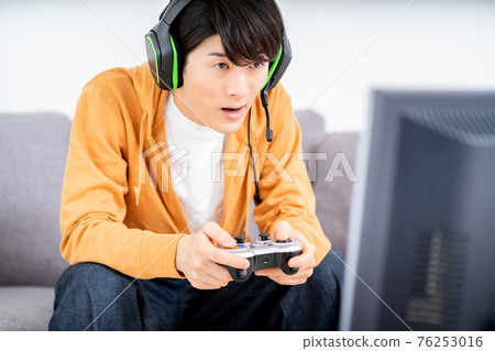 A man playing a net game in the room A man playing a net game in the room 76253016