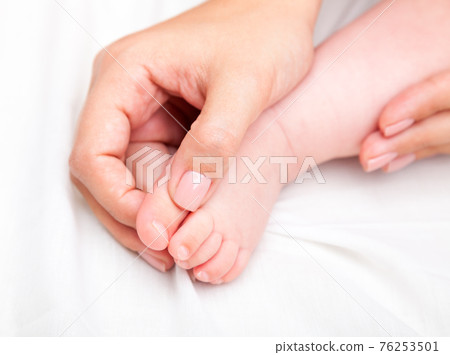 Little baby receiving osteopathic treatment of her foot Little baby receiving osteopathic treatment of her foot 76253501