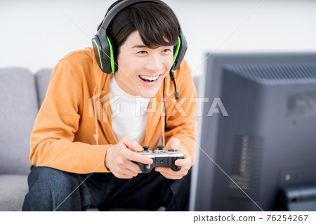 A man playing a net game in the room 76254267