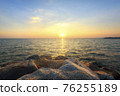 Sunset on the rocky shore of a tropical 76255189