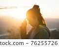 Travel woman enjoy sunset. Close up of travel girl outdoors.. 76255726