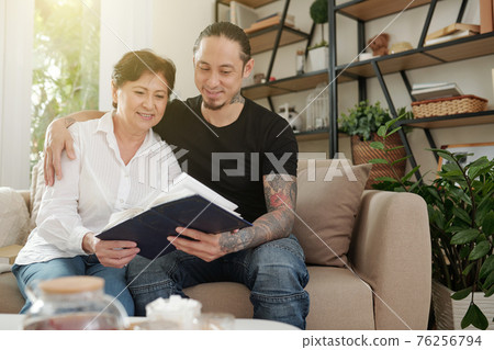 Looking at family album 76256794