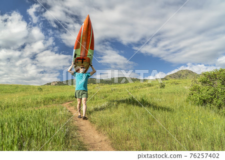 male paddler with stand up paddleboard (SUP) male paddler with stand up paddleboard (SUP) 76257402