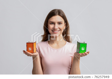 Smiling Woman Holding Small Toy Recycle Bins For Different Type Of Waste Smiling Woman Holding Small Toy Recycle Bins For Different Type Of Waste 76257949