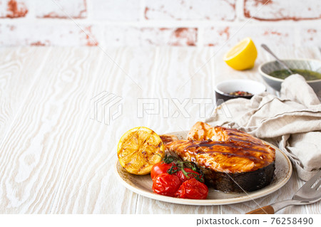 Grilled salmon steak on white wooden background 76258490