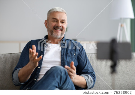 Happy handsome senior man broadcasting from home 76258902