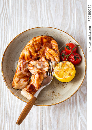 Grilled salmon steak on white wooden background 76260072