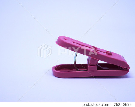 Red plastic clothespin isolated on white background  76260653
