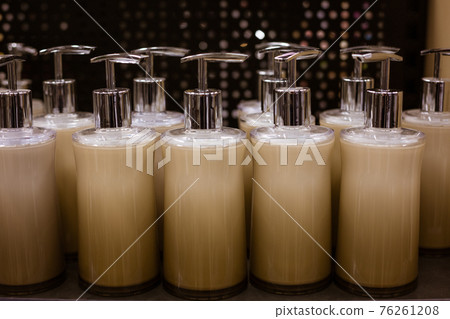 glass liquid soap dispenser on a shelf in a store glass liquid soap dispenser on a shelf in a store 76261208