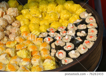 Dim Sum with miscilinous taste in wooden steam cooker. Dim Sum is one of the famous Chinese food. It is cooked by steamed with a high temperature.  76261433