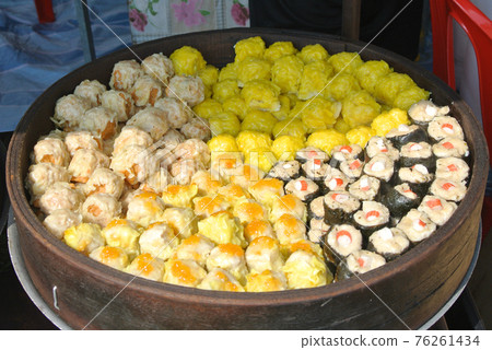 Dim Sum with miscilinous taste in wooden steam cooker. Dim Sum is one of the famous Chinese food. It is cooked by steamed with a high temperature.  76261434