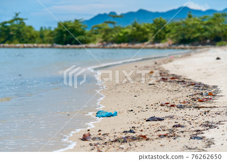 Trash on the sandy beach left by vacationers Trash on the sandy beach left by vacationers 76262650