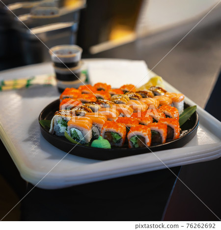 Colorful delicious set of japanese colorful sushi on black plate, ready for eat. Seafood and fast food Colorful delicious set of japanese colorful sushi on black plate, ready for eat. Seafood and fast food 76262692