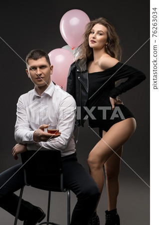 Stylish young couple expecting baby with balloons 76263034