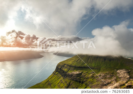 Foggy mountain peaks and clouds covering sea and mountains 76263085