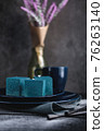 Blue cake filled with orange and tangerine in the shape of a cube. Rustic style. 76263140