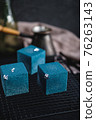Blue cake filled with orange and tangerine in the shape of a cube. Rustic style. 76263143