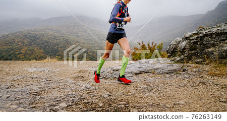 young woman athlete running mountain trail young woman athlete running mountain trail 76263149