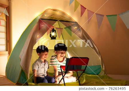 Boys enjoying home camp 76263495