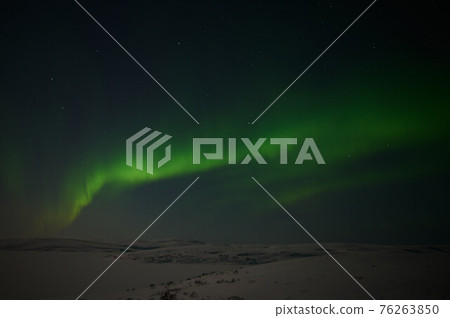 northern light on the silent field before sun rise. 76263850