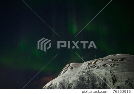 northern light on the silent field before sun rise. northern light on the silent field before sun rise. 76263916