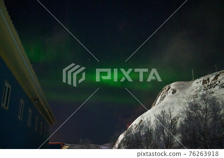 northern light on the silent field before sun rise. northern light on the silent field before sun rise. 76263918