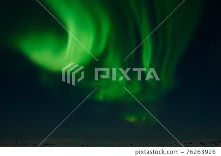 northern light on the silent field before sun rise. northern light on the silent field before sun rise. 76263926