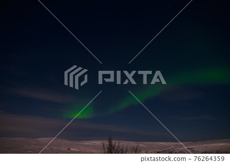 northern light on the silent field before sun rise. 76264359