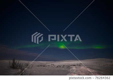 northern light on the silent field before sun rise. 76264362