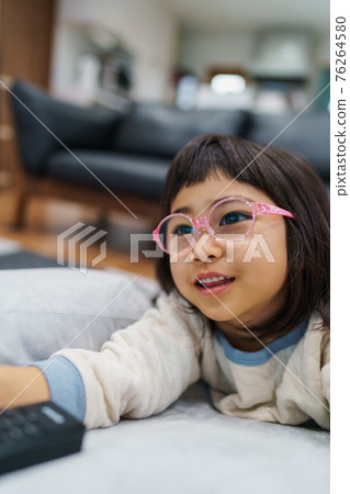 Children wearing glasses watching TV 76264580