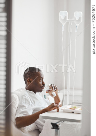 Man Eating Food in Hospital Side View 76264673