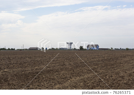 Rural landscape with houses and a radio telescope on the horizon. Vitino village in Saki district 76265371