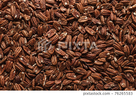 Pecan nuts background, top view. Pecans fruits texture, close-up Pecan nuts background, top view. Pecans fruits texture, close-up 76265583