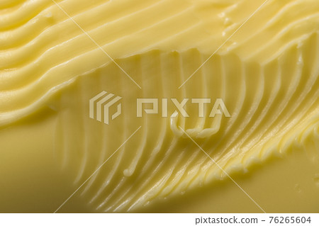 Grooves and swirls made by a kitchen knife taking margarine to spread. Grooves and swirls made by a kitchen knife taking margarine to spread. 76265604