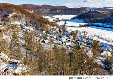 Streitberg, Germany. Winter landscape, view from the Streiburg castle ruins to the town of Streitberg in the valley Streitberg, Germany. Winter landscape, view from the Streiburg castle ruins to the town of Streitberg in the valley 76265958