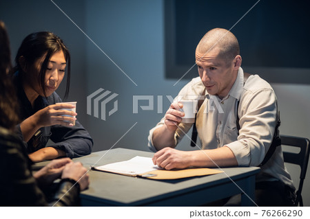 An experienced investigator and a female police officer interrogate the suspect An experienced investigator and a female police officer interrogate the suspect 76266290