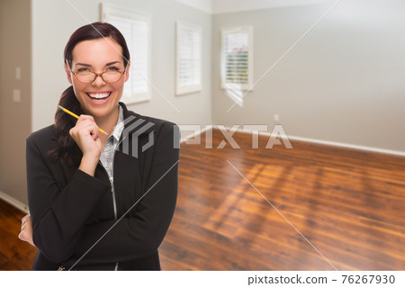 Woman With Pencil In Empty Room of New House 76267930