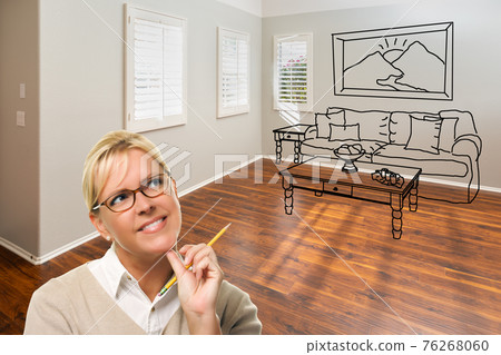 Woman With Pencil In Empty Room of New House with Couch and Table Drawing on Wall 76268060