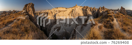 The picturesque panorama of Cappadocia at sunset, amazing Turkey, Mountains and rock formation, big size image, Goreme national park, Love valley, open air museum, ancient region of Anatolia, Unesco The picturesque panorama of Cappadocia at sunset, amazing Turkey, Mountains and rock formation, big size image, Goreme national park, Love valley, open air museum, ancient region of Anatolia, Unesco 76269408
