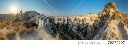 The picturesque panorama of Cappadocia at sunset, amazing Turkey, Mountains and rock formation, big size image, Goreme national park, Love valley, open air museum, ancient region of Anatolia, Unesco The picturesque panorama of Cappadocia at sunset, amazing Turkey, Mountains and rock formation, big size image, Goreme national park, Love valley, open air museum, ancient region of Anatolia, Unesco 76270297