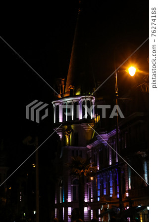 Illuminated former National bank building with the famous unique astronomical clock tower on Europe square in Batumi, Georgia. Night view Illuminated former National bank building with the famous unique astronomical clock tower on Europe square in Batumi, Georgia. Night view 76274188