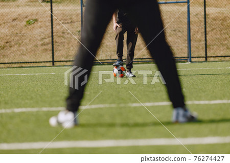 Spormen is playing football and practising with the ball 76274427